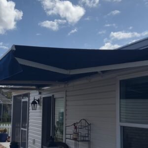 Upgrade your outdoor living with the SunShield Retractable Awning, combining high-end performance, bold style, and effortless control. This 19'6" wide awning with an 8-foot projection is dressed in Sunbrella® Marine Blue (FF 4678-0000) — a premium, weather-resistant fabric known for its durability, rich color, and fade resistance.